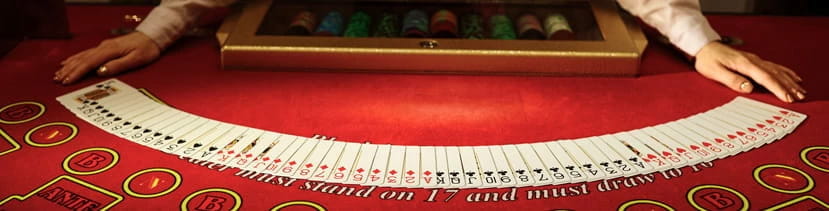 A dealer shows the deck on a table.